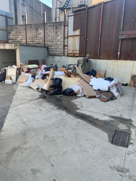 Photo of a pile of material being thrown away at Arts Gowanus after Hurricane Ida