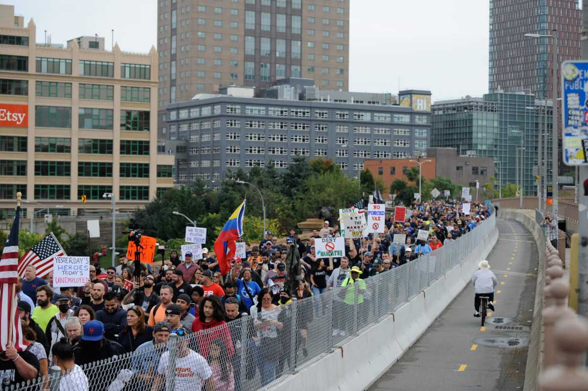 Protestors walk the Brooklyn Bridge.