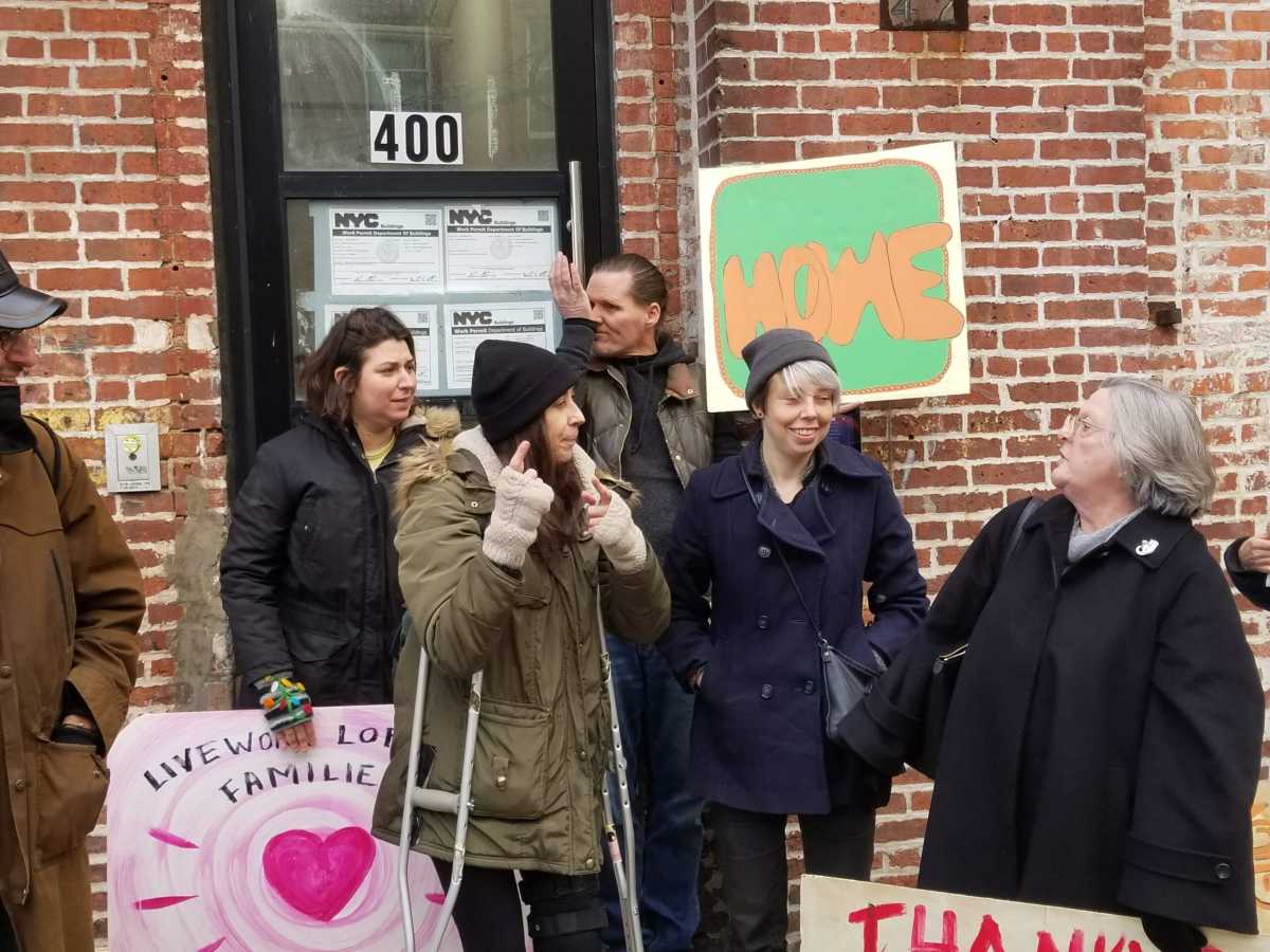 People speak at the press conference announcing the new loft law