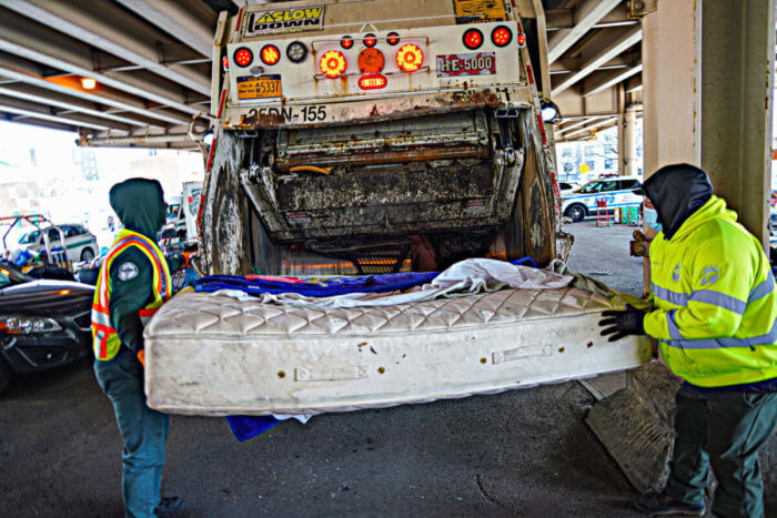 people put mattress in trash at an encampment sweep