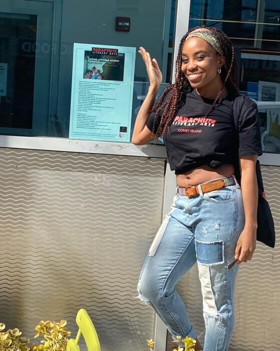 woman posing with poem at coney island poetry map