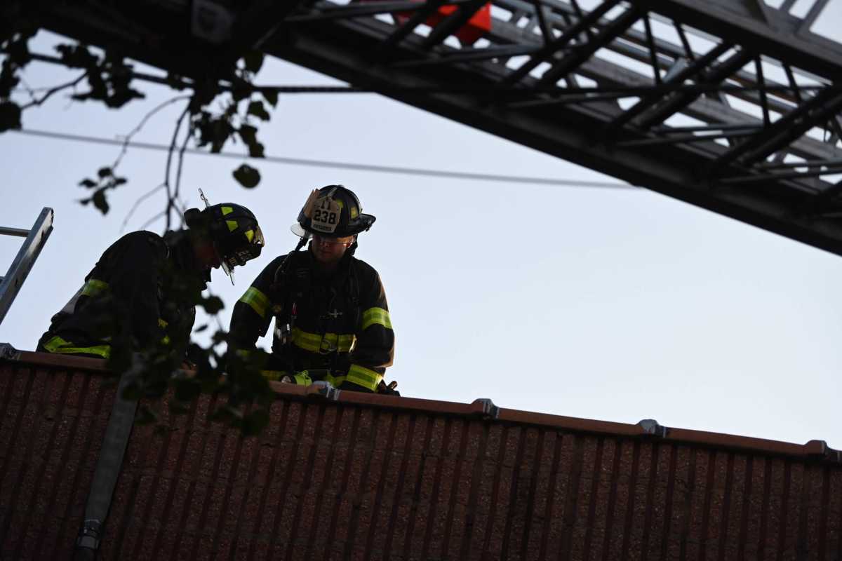 firefighters on the roof of building at two-alarm fire