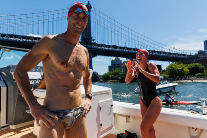 peolpe on a boat during open water swim