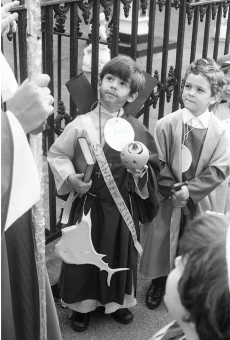 child in religious garb looking up in chasing church news