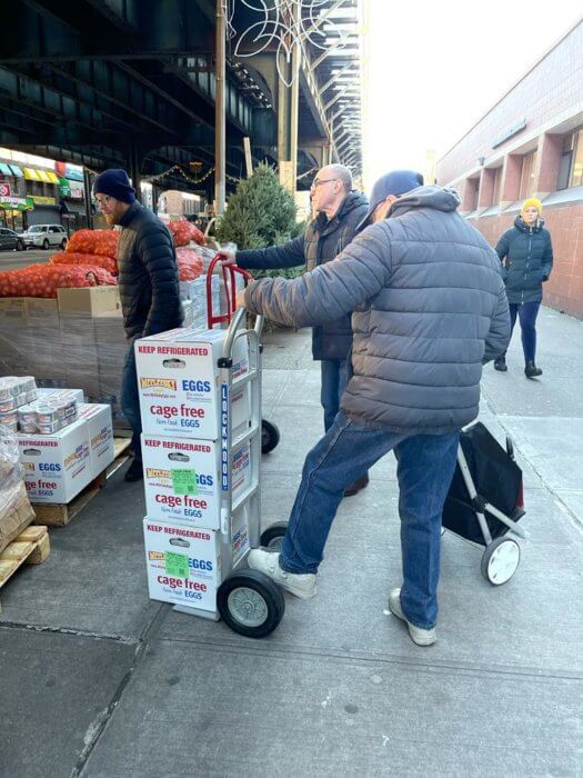 Volunteers prepare their weekly food pantry from hungry refugees.