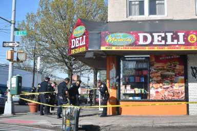 Police investigate the scene where a gunman fatally shot a man in Canarsie.