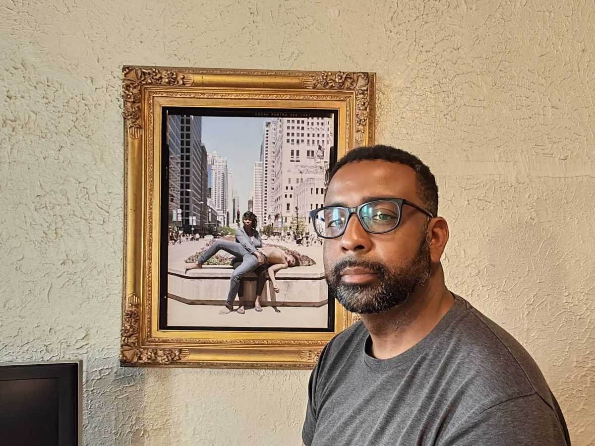 Jon Henry in front of photo from stranger fruit