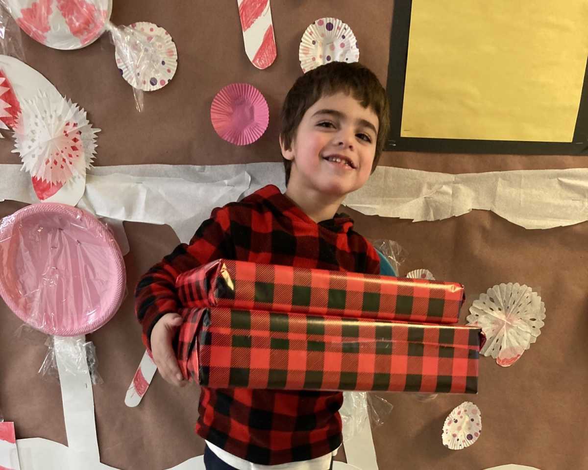 Kid with autism at Birch Family Servoces christmas gift drive