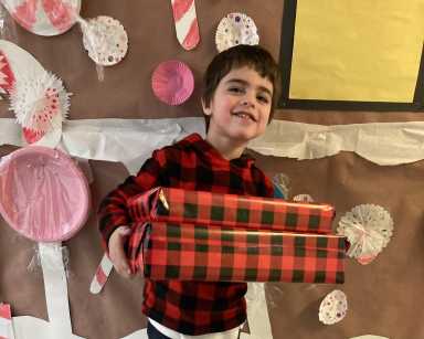 Kid with autism at Birch Family Servoces christmas gift drive