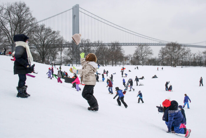 kids playing in park after snowstorm