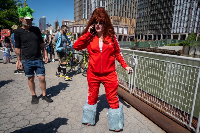 woman in red tracksuit with fake "cement boots"