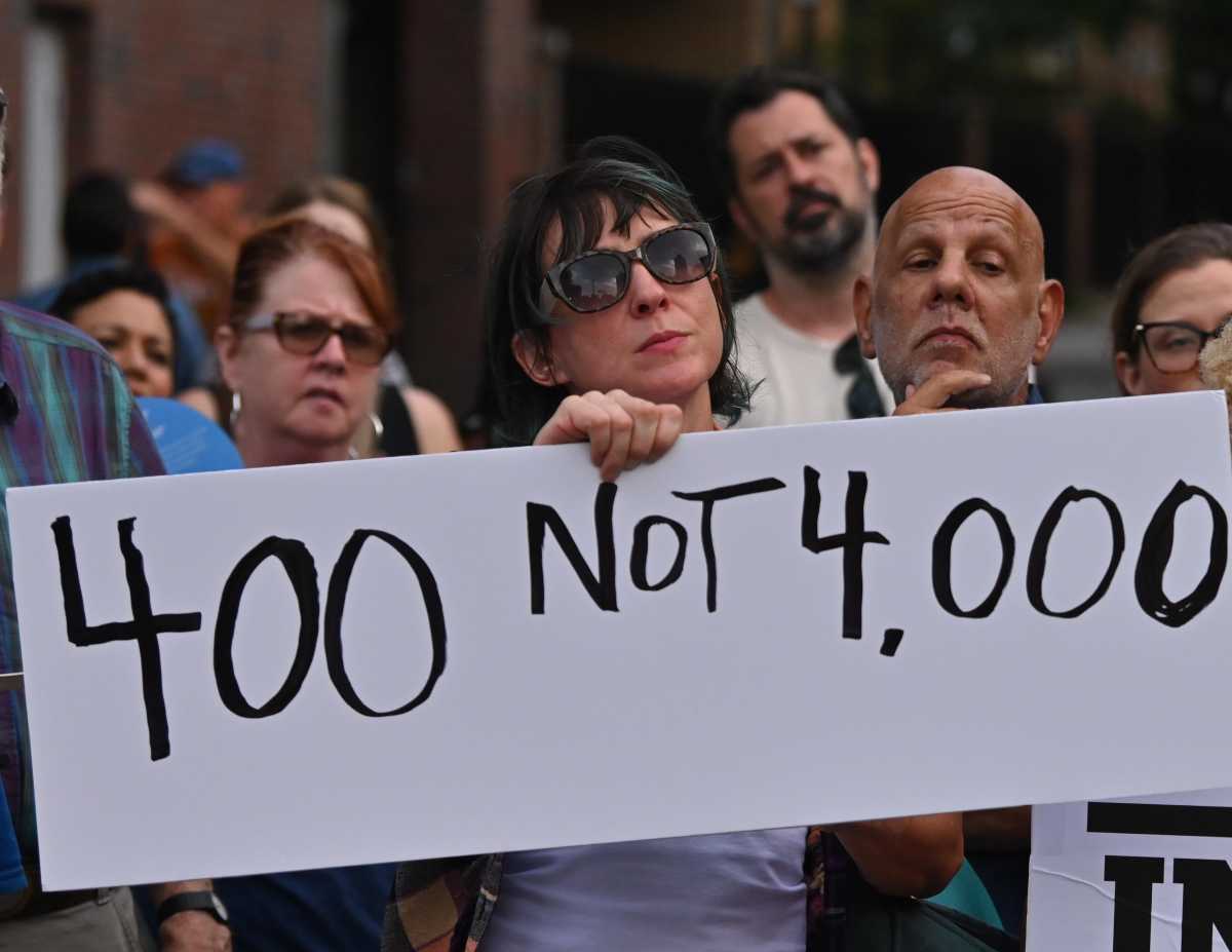 woman holding sign clinton hill shelter protest