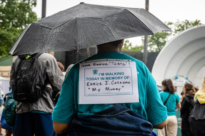 woman with memorial sign at T.E.A.L. ovarian cancer walk