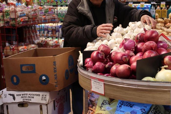 person shopping for onions