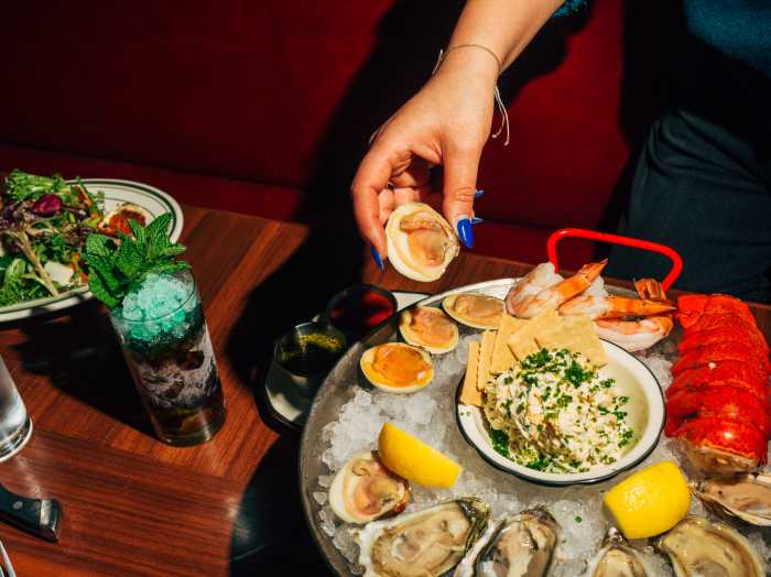 person eating oysters at JR & Son